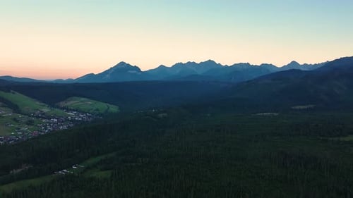 Majestic mountain landscape at dawn with valleys and peaks in soft light