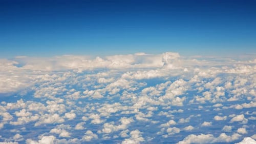 Aerial View of Fluffy Clouds and Blue Sky
