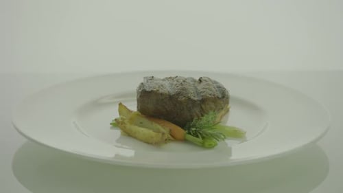 Gourmet Steak Dish on a White Plate