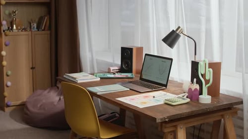 Wooden Desk with Laptop and Office Supplies on Top in Room