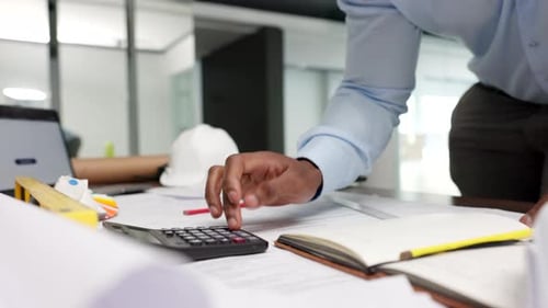 Construction manager working on budget, planning business strategy and making finance calculations