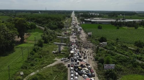 Aerial shot of huge trafic jam in india due to railway crossing line closed.