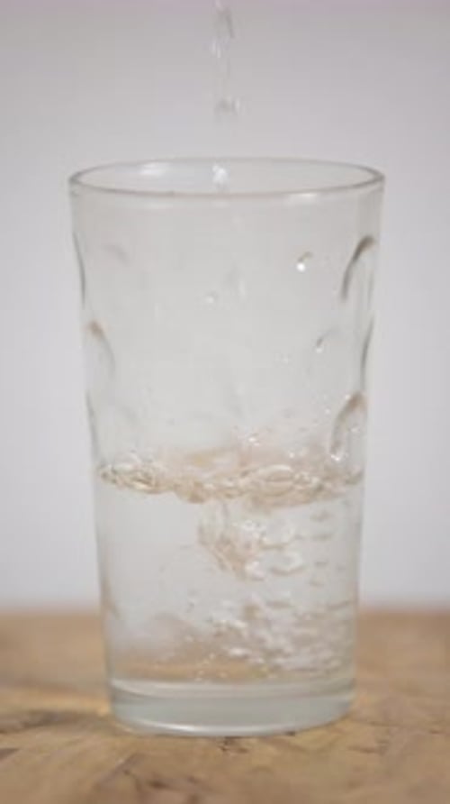Water being poured into drinking glass close-up shot
