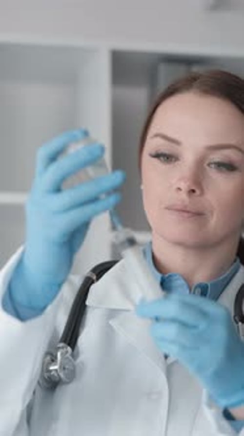 Medical Professional Filling Syringe in Hospital Lab