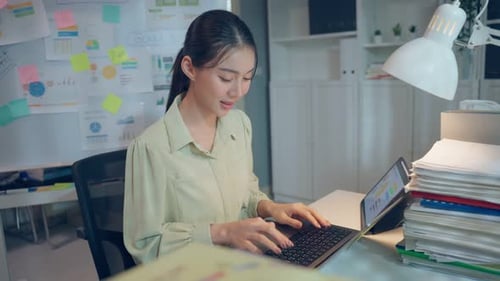 Asian beautiful businesswoman using laptop computer working in office.