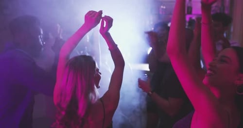 Dancing, nightclub and women with crowd for party, new years eve event and birthday rave