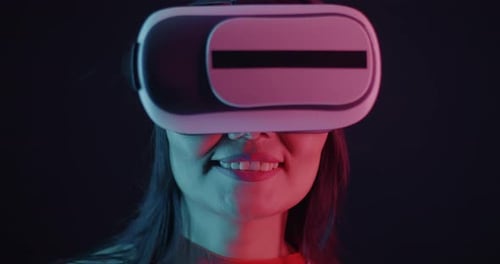 Smiling Young Adult Wearing VR Headset