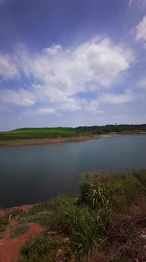 Les
traces de pas mènent au lac Ray au Vietnam. Un petit bateau dérive sur l'eau. Le ciel bleu emplit
