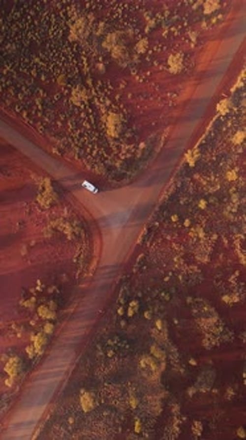 Aerial view of rugged landscape with winding road, Australia.
