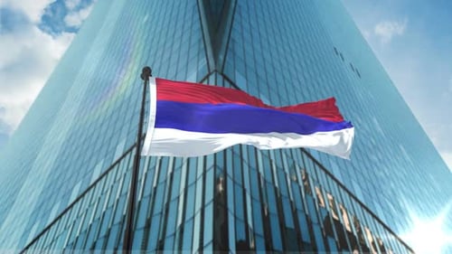 Waving Flag Animation in Front of Modern Skyscraper