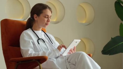 Female Doctor Works in the Office of a Modern Clinic a Doctor with a Tablet Computer a Doctor in a