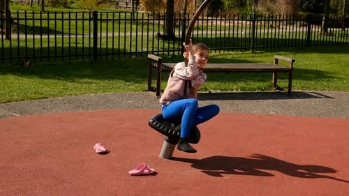 A Child is Riding on a Swing Selective Focus