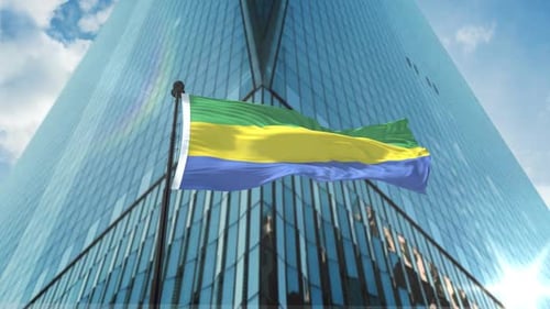 National Flag Waving Over Modern Corporate Building