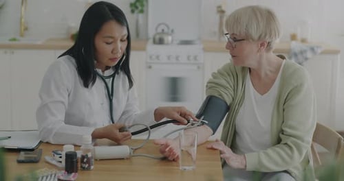 Doctor Checks Patient's Blood Pressure at Home