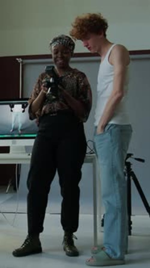 Photographer Showing Photos to Model in Studio