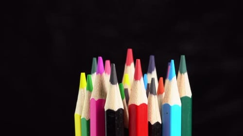 Colorful Pencils Arranged Closely Together on Black Background