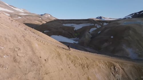 Man hiking at the scenic dramatic volcanic landscape in Iceland