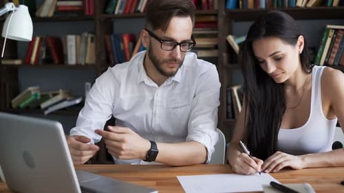 Two Students Brainstorming Work By Discuss With Desktop In Hipster Loft Closeup With Background B...