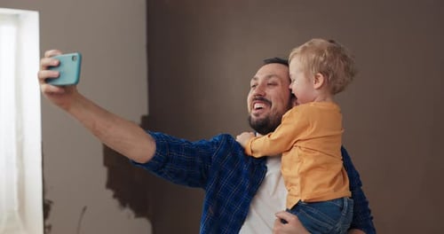 Dad and Child Take Adorable Selfie at Home