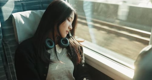 Train, commute and woman on journey sleeping on transportation in Japan with headphones
