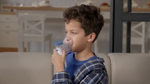 Boy Uses Nebulizer Mask for Treatment at Home