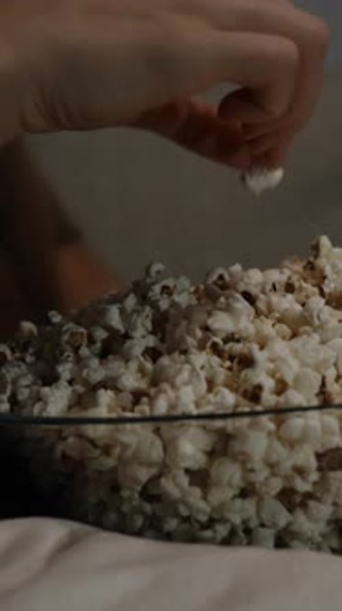 Woman Eating Popcorn in a Bowl Close Up