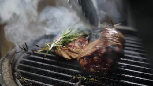 Chef cooks meat on the grill