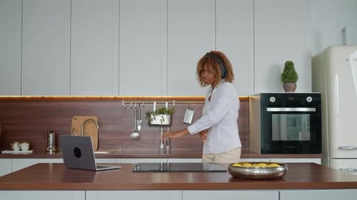 Woman Dancing in Kitchen While Working From Home