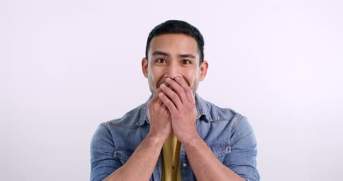 Wow, face and an Asian man with surprise and excited isolated on a white background in a studio