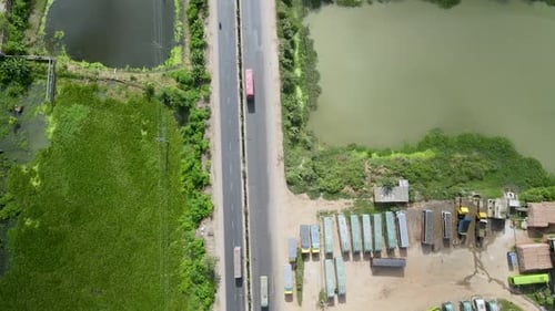 Vehicles are moving from a beautiful road in Dhaka city nearby a lake