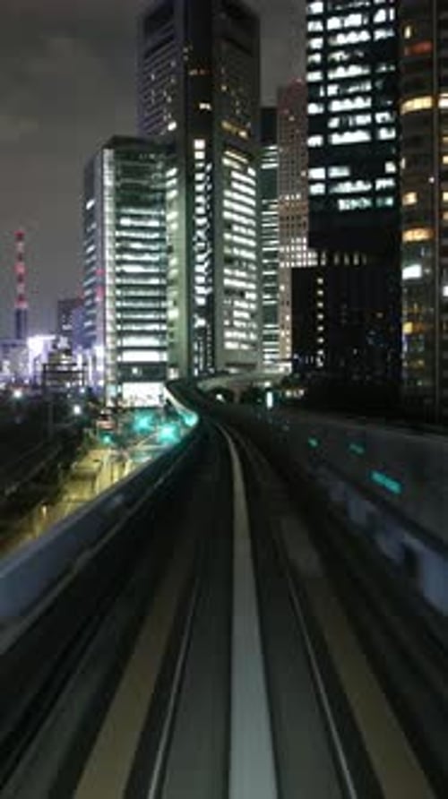 Tokyo Monorail Passing Through the City's Skyscapers in Vertical