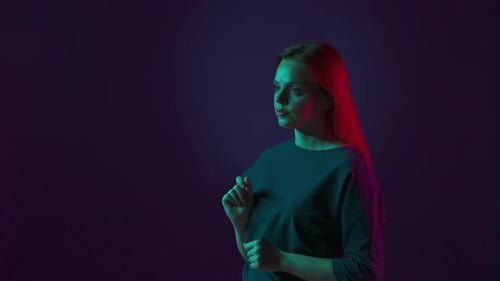 A Young Woman Scrolls Through an Invisible Screen with Her Finger and Hand Portrait of a Woman in