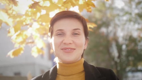 Autumn Outdoor Portrait of Beautiful Young Woman Female Walking in the Fall Park Enjoying Weekend