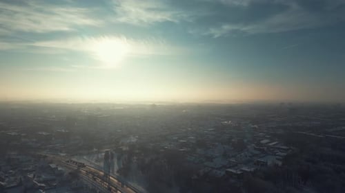 Drone Flying Above City. Panoramic City View At Sunset In Winter. Cinematic Drone Winter Footage