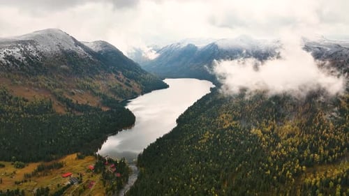 Aerial view of a mountain resort by a lake in autumn