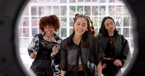 Happy, friends and girls with ring light for dance in studio with live streaming