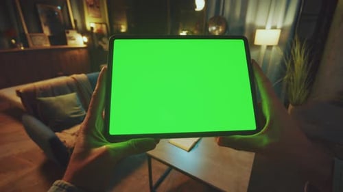 Close Up Hands Man Holding Scrolling and Tapping on Tablet Computer with Horizontal Green Screen