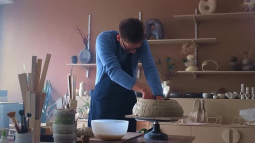 A Talented Male Potter Creates a Vase or Pot From Raw Clay A Professional Male Artist Sculpts in a