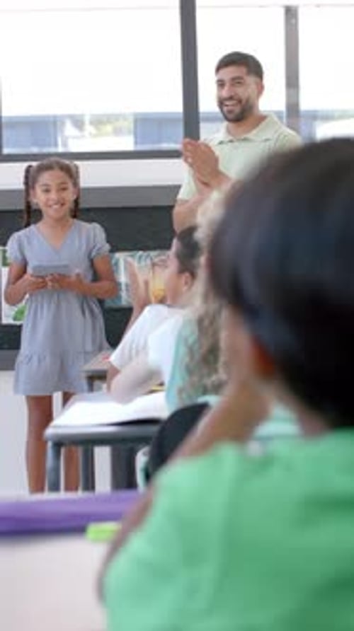 Vertical video: In school, young girl stands presenting to her class