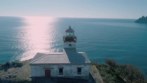 Aerial Panoramic View of White Lighthouse on the Rocky Cliff at Seaside Beautiful Seascape