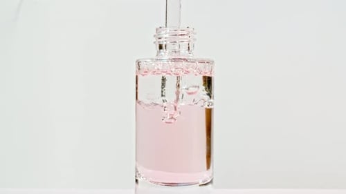 Liquid being poured into a clear bottle