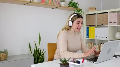 Young Woman Having a Video Call on Laptop From Home Office