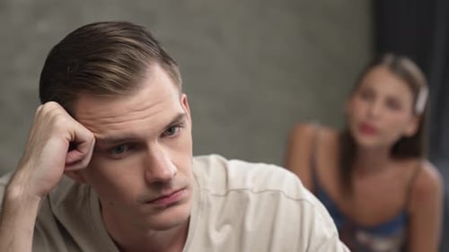 Upset Man and Arguing Woman in Home Interior