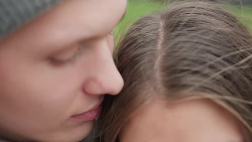 Romantic Close Up of Man Kissing Woman Head in Peaceful Loving Moment