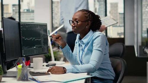 Financial Analyst in Prop Firm Office Doing Research on Stock Market Shares