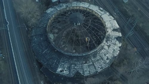 drone flying above an abandoned train shed