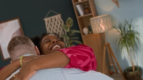 Smiling Couple Share Affectionate Hug at Home