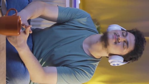 Man Listening to Music at Home, Vertical Video