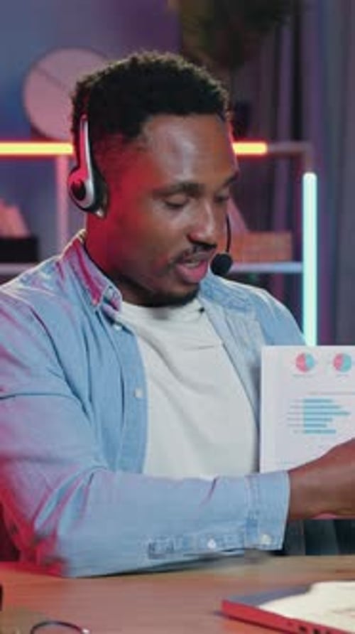 Young Man Explains Charts During Virtual Meeting