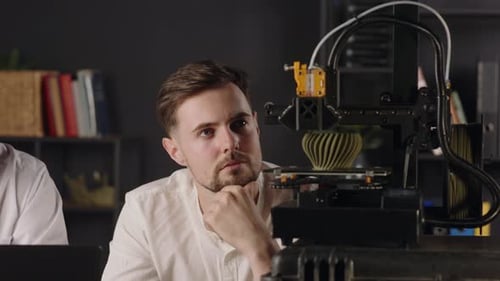 A Concentrated Young Guy Mechanical Engineer with Interest Observes the Working Process of 3d